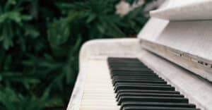 Old white piano outdoors